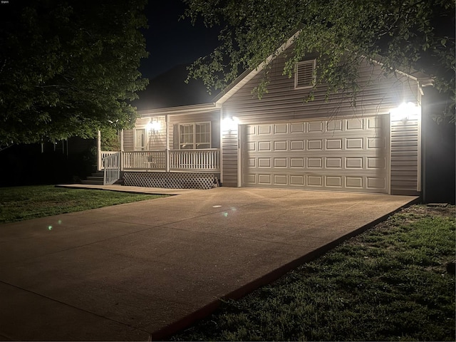 view of front facade featuring covered porch, concrete driveway, and a garage
