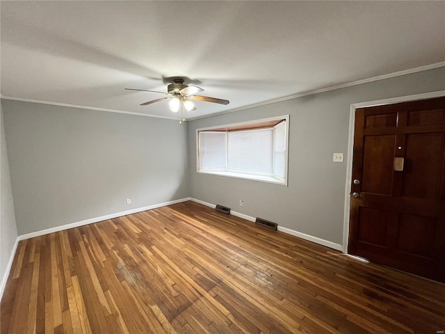 entrance foyer with hardwood / wood-style floors, ornamental molding, visible vents, ceiling fan, and baseboards