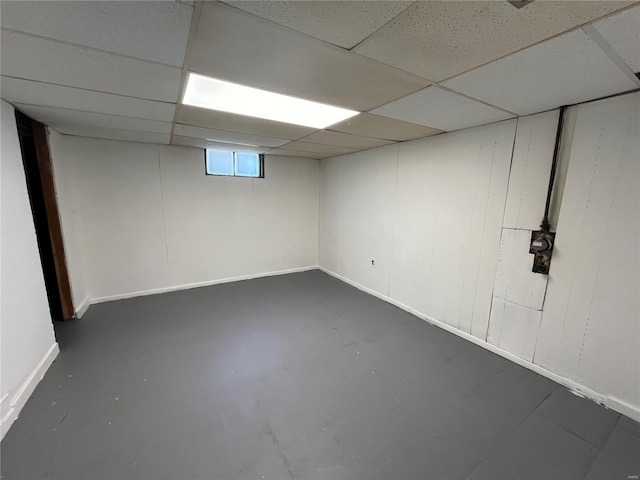 below grade area featuring a drop ceiling and baseboards