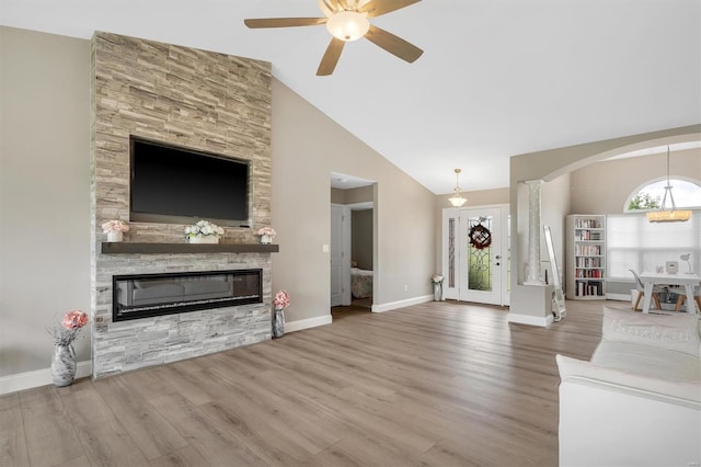 unfurnished living room with lofted ceiling, a wealth of natural light, and wood finished floors