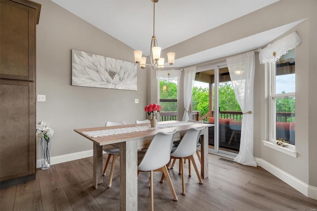 dining area featuring a wealth of natural light, baseboards, and a notable chandelier