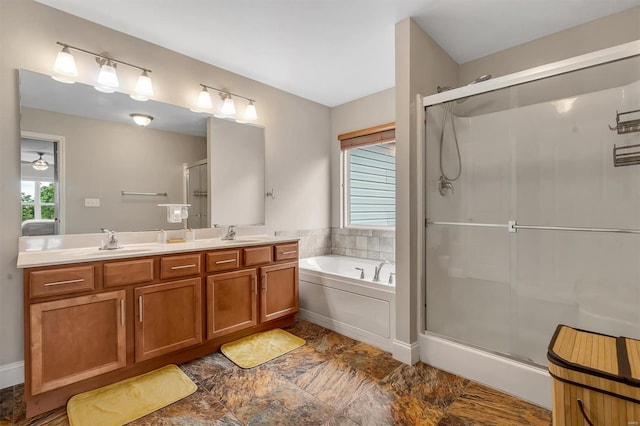 full bathroom featuring a stall shower, a garden tub, double vanity, and a sink