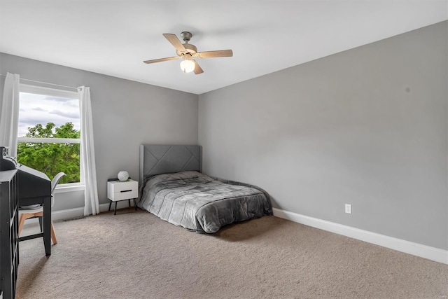 bedroom with baseboards, carpet flooring, visible vents, and a ceiling fan