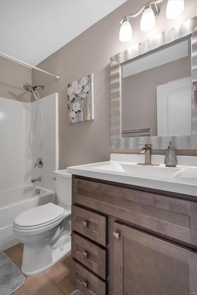 full bath with vanity, toilet, shower / bathtub combination, and wood finished floors