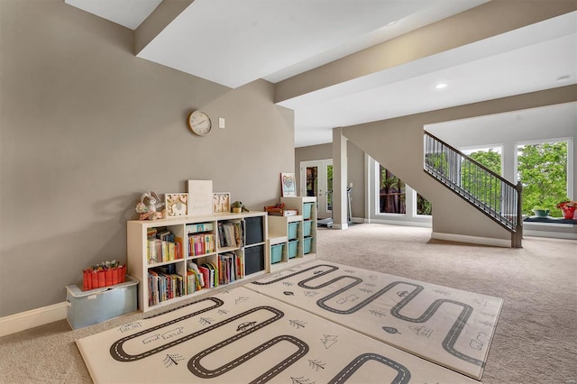 playroom featuring carpet floors and baseboards