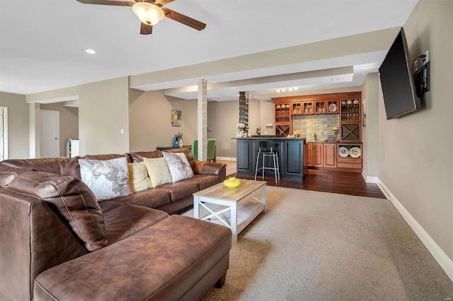 living area with recessed lighting, baseboards, dark colored carpet, ceiling fan, and indoor wet bar