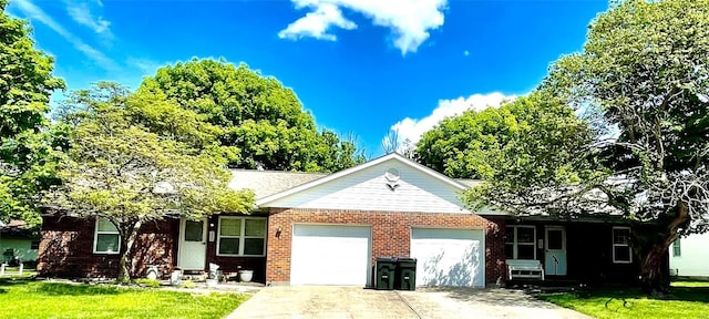 single story home featuring concrete driveway, a front yard, brick siding, and a garage
