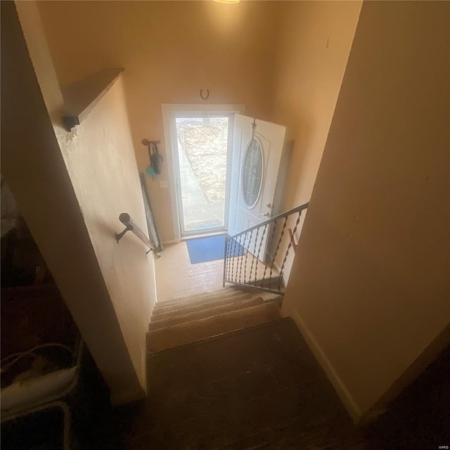 staircase featuring baseboards