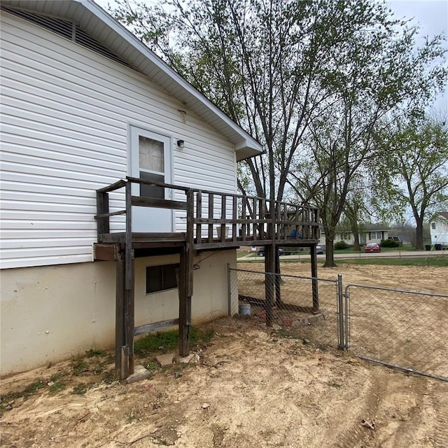 view of side of property with fence and a deck