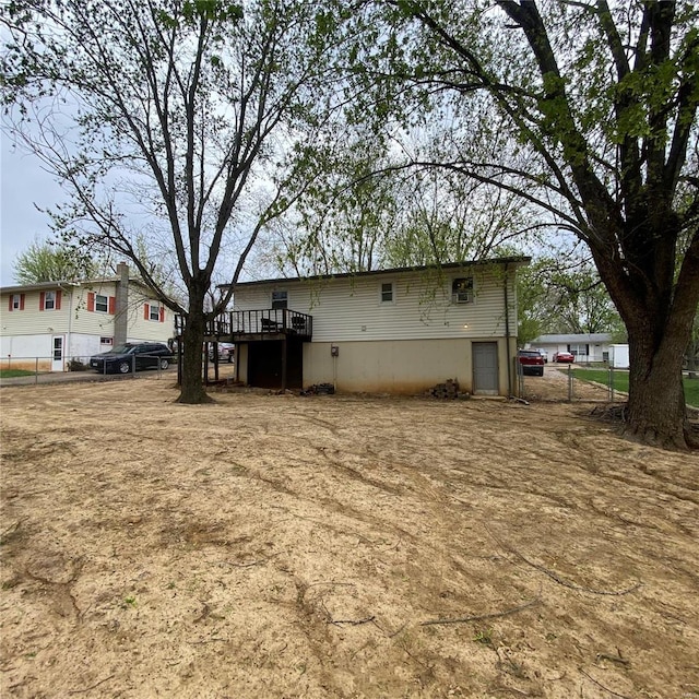 back of property featuring a wooden deck and fence