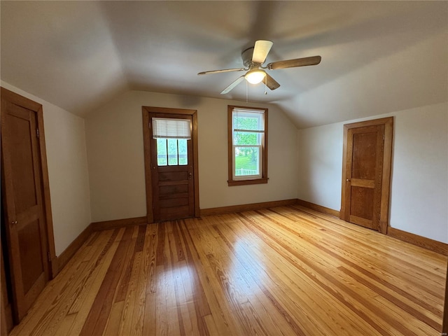 bonus room featuring vaulted ceiling, ceiling fan, baseboards, and light wood-style floors
