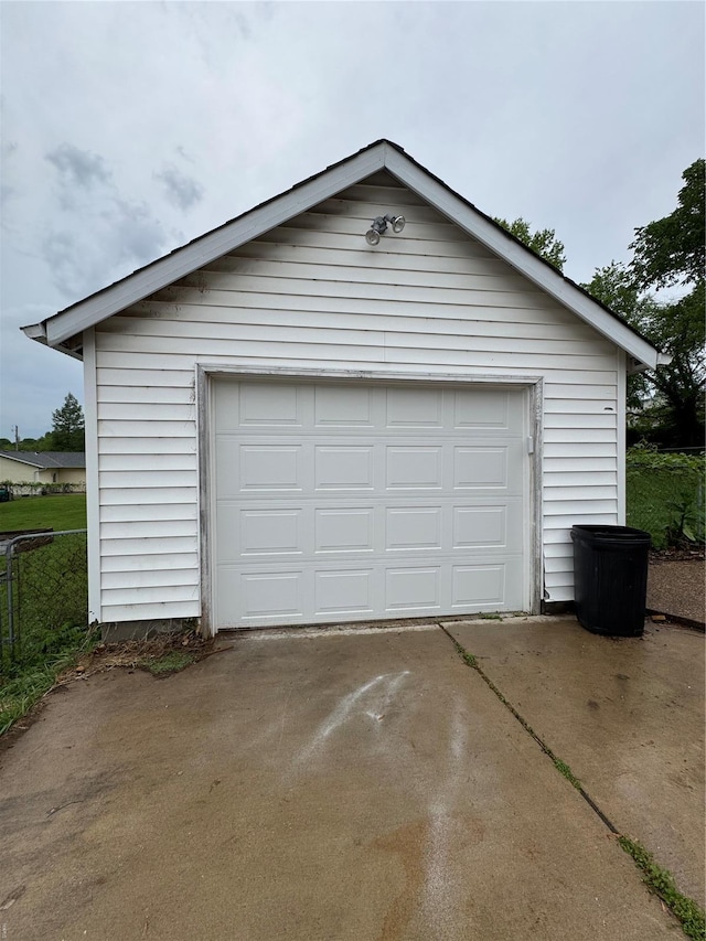 detached garage with concrete driveway