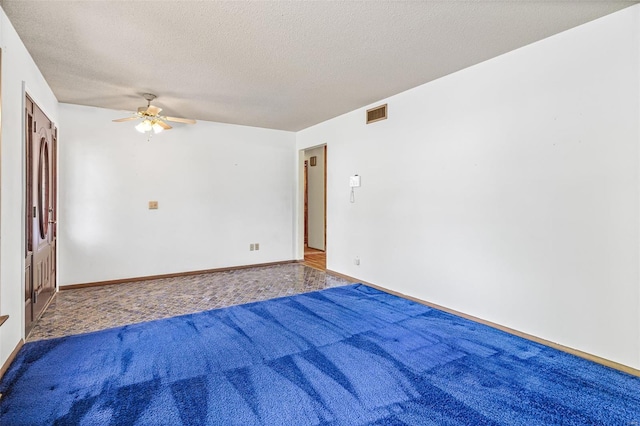 unfurnished room with ceiling fan, a textured ceiling, carpet floors, and baseboards