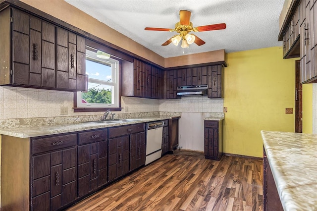 kitchen featuring dishwasher, a sink, under cabinet range hood, a ceiling fan, and light countertops