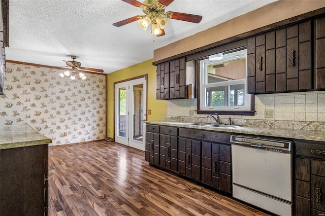 kitchen featuring dishwasher, a sink, a ceiling fan, dark brown cabinetry, and dark wood-type flooring