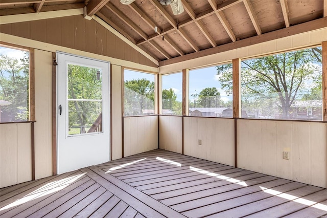 unfurnished sunroom featuring vaulted ceiling and wooden walls