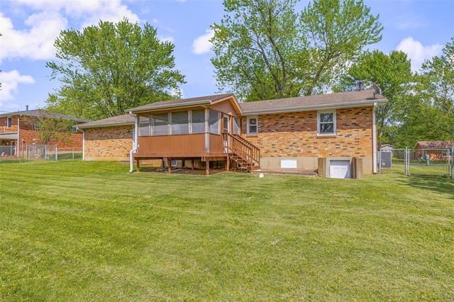 rear view of house with a sunroom, a gate, and brick siding