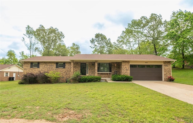 ranch-style house featuring a garage, a front lawn, brick siding, driveway, and central AC unit