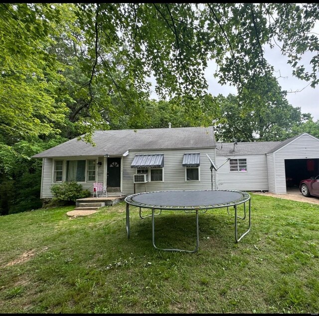 back of property featuring a lawn