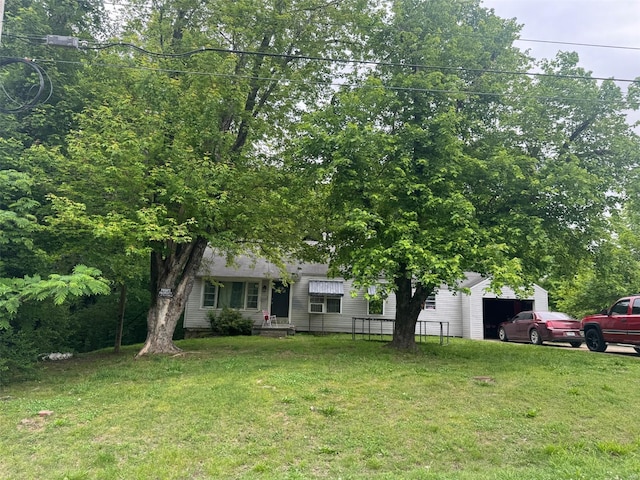 obstructed view of property featuring a front yard and an attached garage