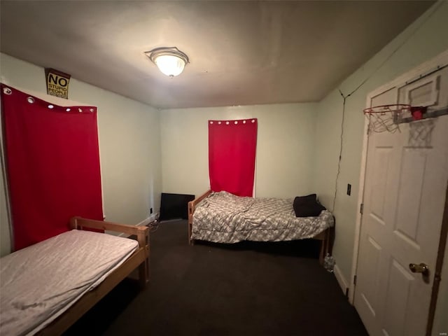 bedroom with carpet floors and baseboards