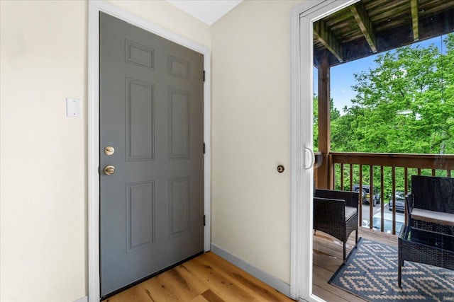 entrance to property with stucco siding, a wooden deck, and an outdoor living space