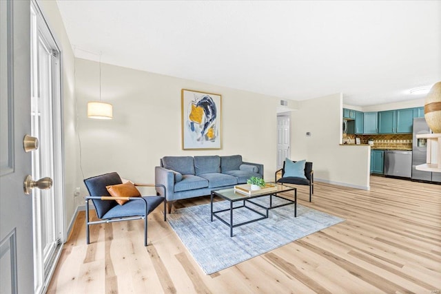 living room with light wood finished floors and baseboards