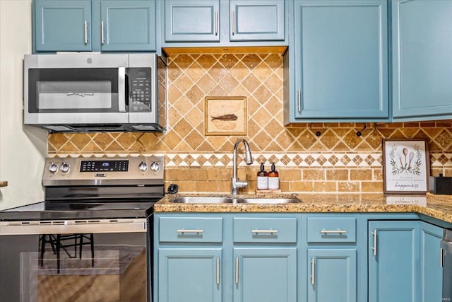 kitchen with appliances with stainless steel finishes and blue cabinets