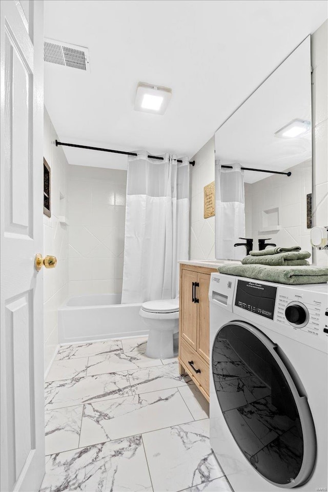 bathroom with washer / clothes dryer, marble finish flooring, shower / bath combo with shower curtain, vanity, and toilet