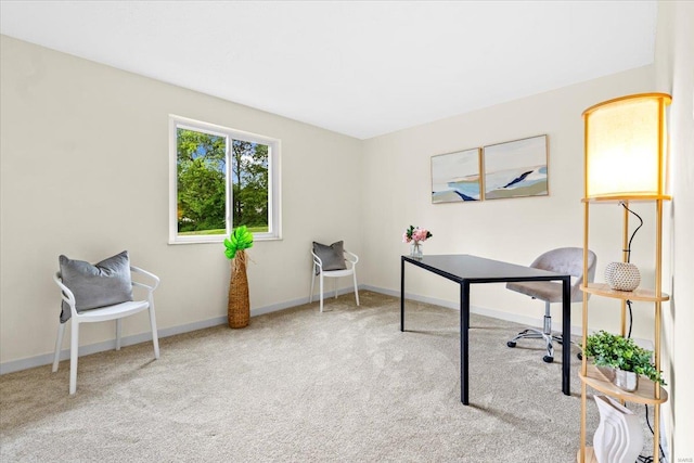 carpeted home office featuring baseboards