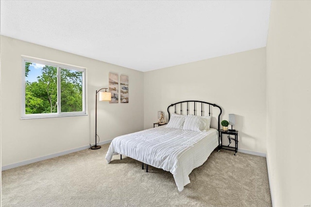 bedroom featuring carpet and baseboards