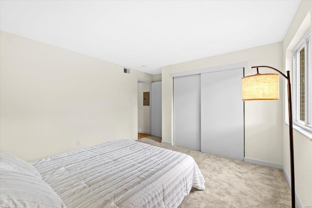 bedroom featuring carpet, a closet, and baseboards