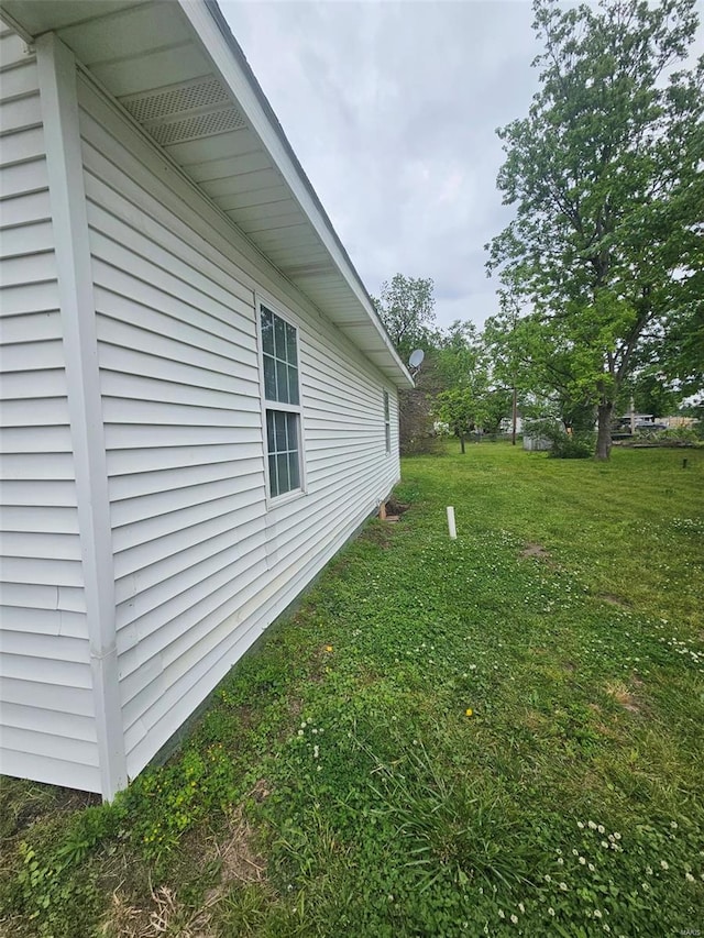 view of home's exterior with a lawn