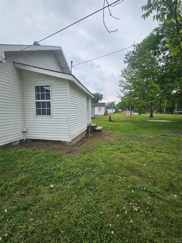 view of side of home featuring a lawn