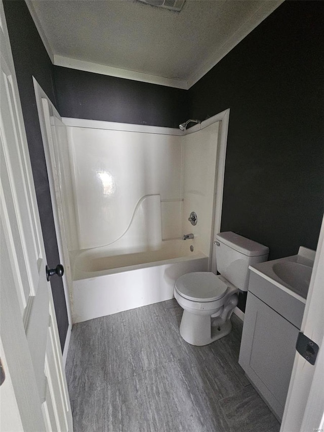 full bathroom with toilet, wood finished floors, shower / tub combination, and vanity