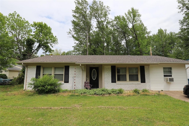 single story home with brick siding, a front yard, and cooling unit