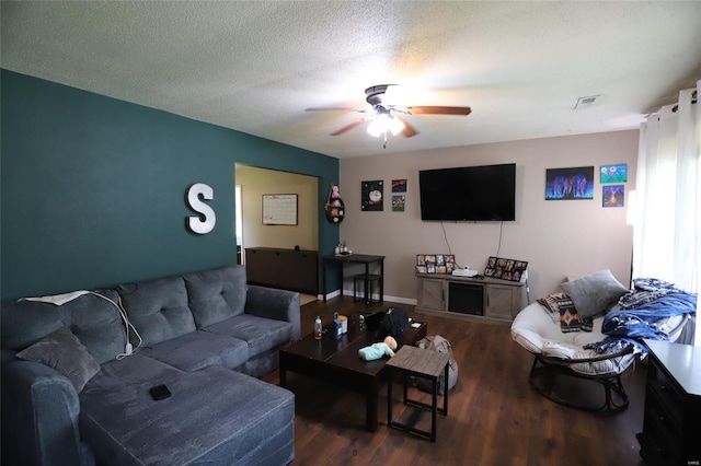 living area with a ceiling fan and wood finished floors