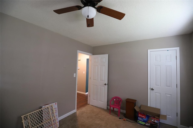unfurnished bedroom featuring carpet flooring, ceiling fan, and baseboards