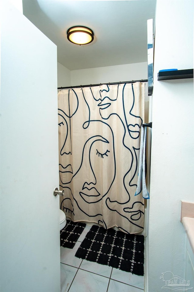 bathroom featuring vanity, toilet, tile patterned floors, and curtained shower