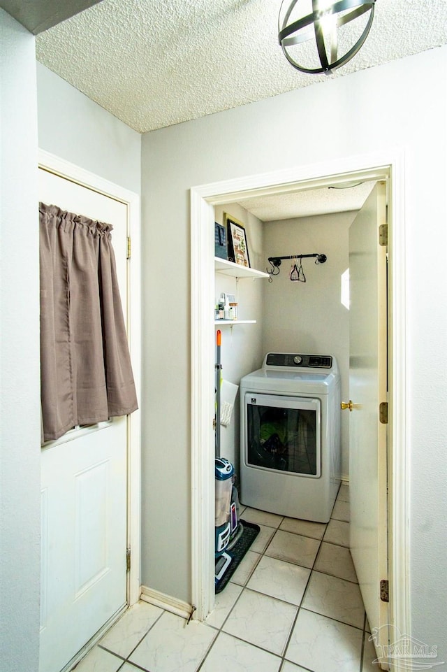 washroom featuring washer / dryer and a textured ceiling