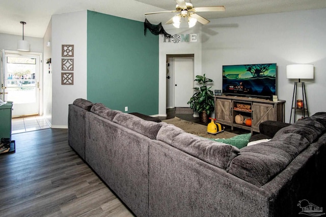 living room with wood-type flooring and ceiling fan