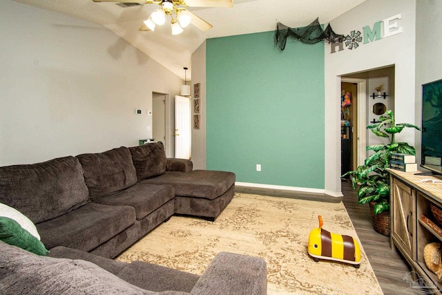 living room featuring hardwood / wood-style floors, high vaulted ceiling, and ceiling fan