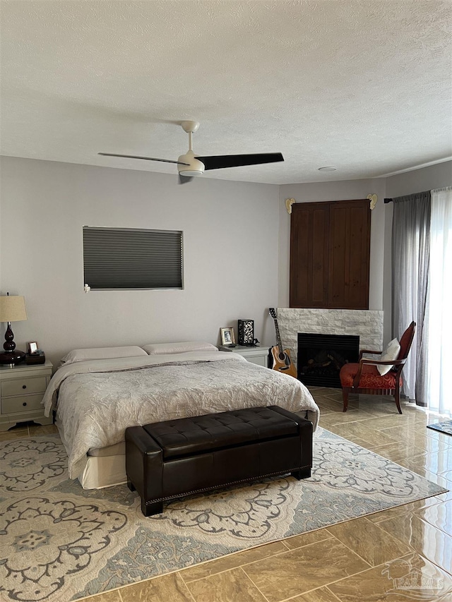 bedroom featuring a textured ceiling and ceiling fan