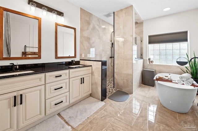 bathroom featuring tile walls, vanity, and shower with separate bathtub