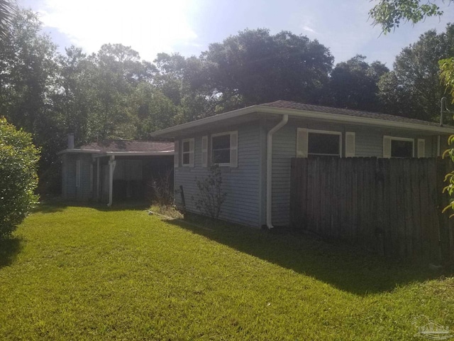 view of side of property with a lawn