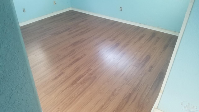 unfurnished room with hardwood / wood-style floors