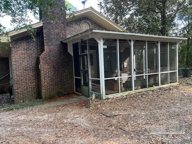 back of house featuring a sunroom