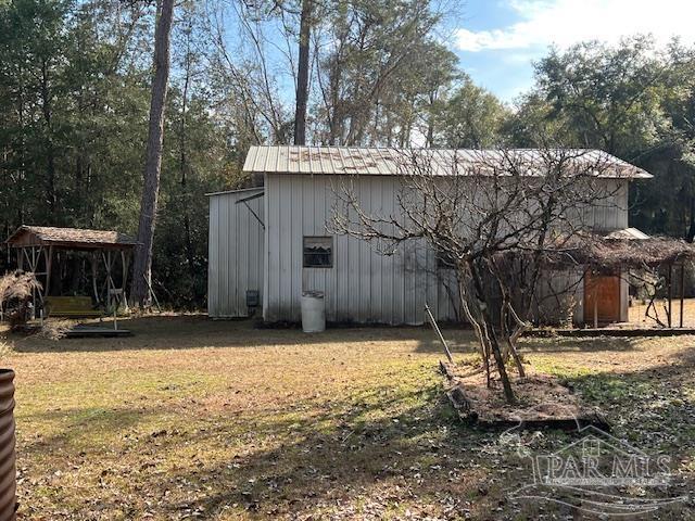 view of outdoor structure featuring a lawn