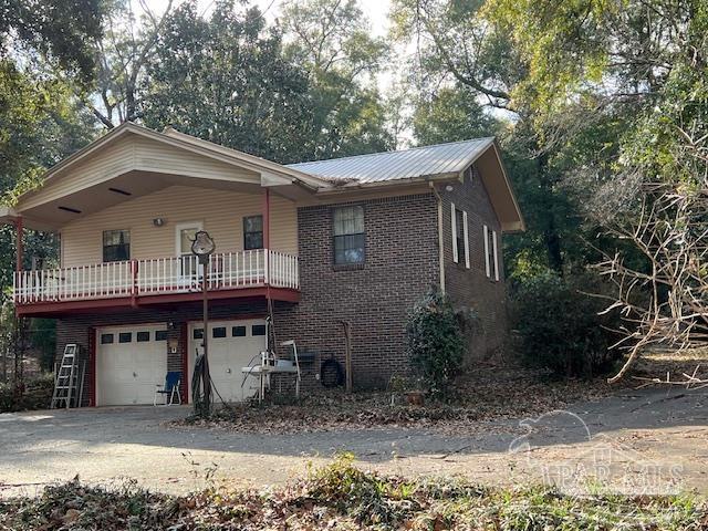 view of front facade featuring a balcony and a garage