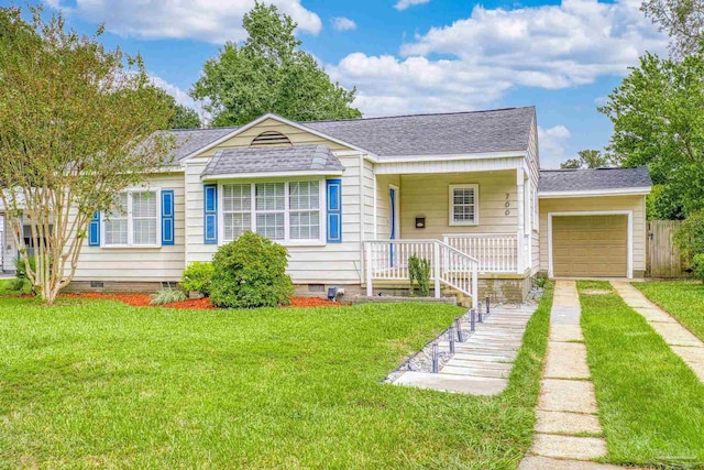 view of front of house featuring a front lawn, covered porch, and a garage